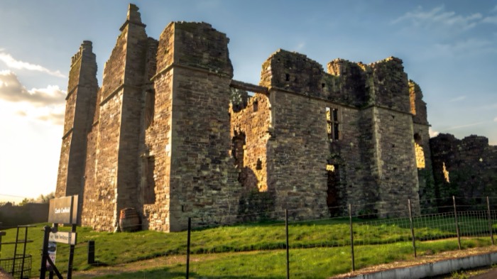 The ruined manor house walls of Castle Caulfield against an evening sky