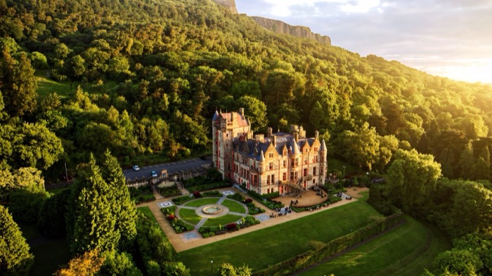 Aerial view of Belfast Castle and its formal gardens on the wooded slopes of Cave Hill