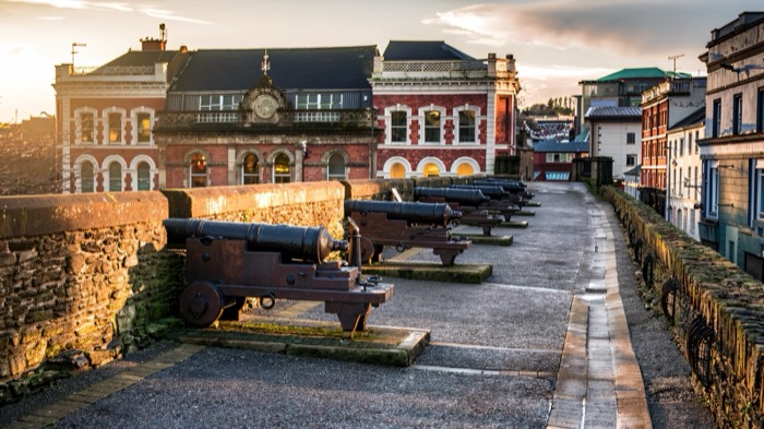 Cannon lining the ramparts of Derry's Walls at sunset