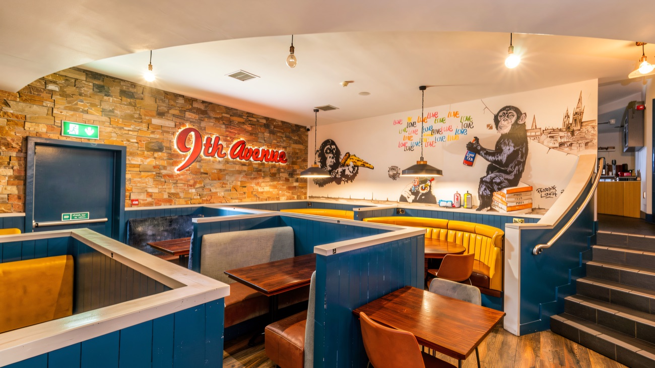 9th Avenue's signature seating booths and Banksy-style mural