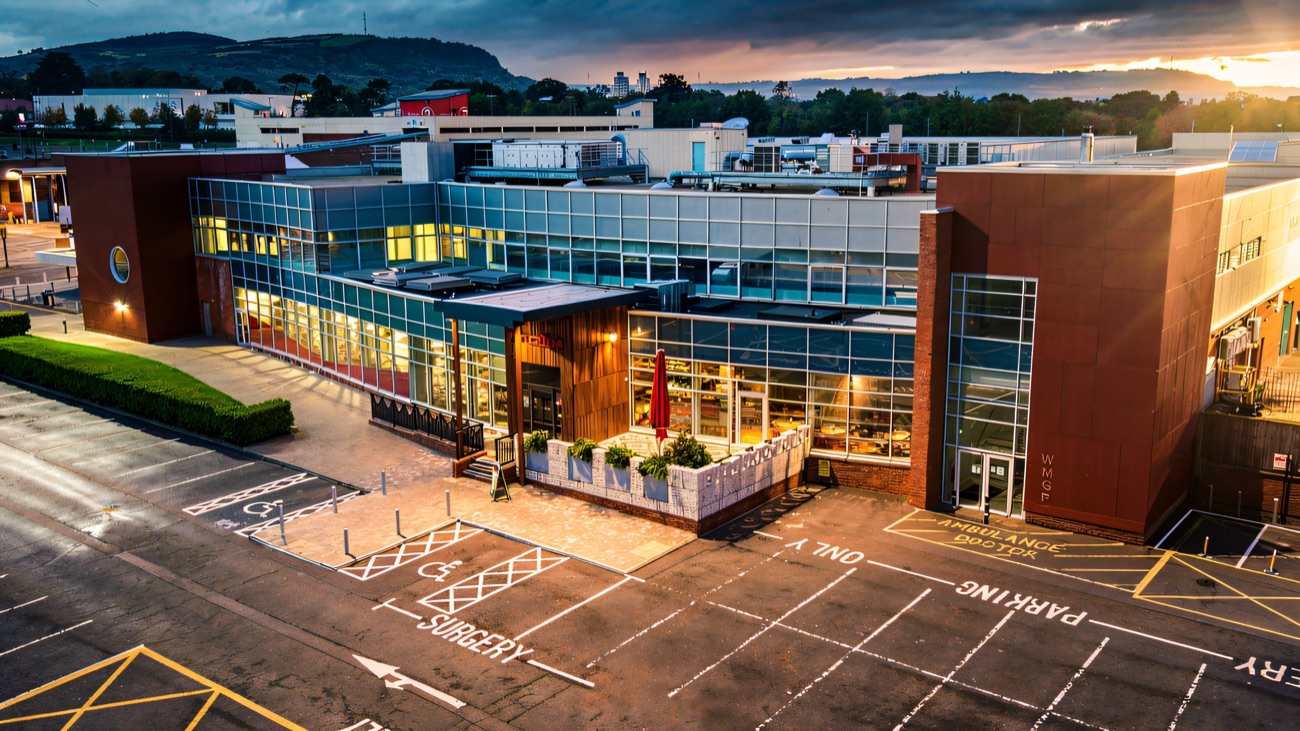 The Abbey Centre from above, with the Nando's terrace at the front of the building and Cave Hill rising behind