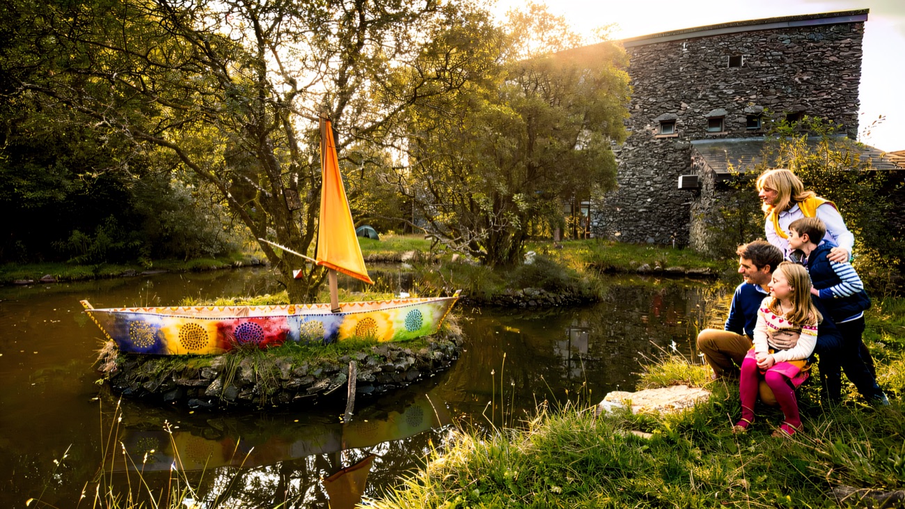 The willow-and-colour boat moored on the little pond, a favourite family spot in the grounds.