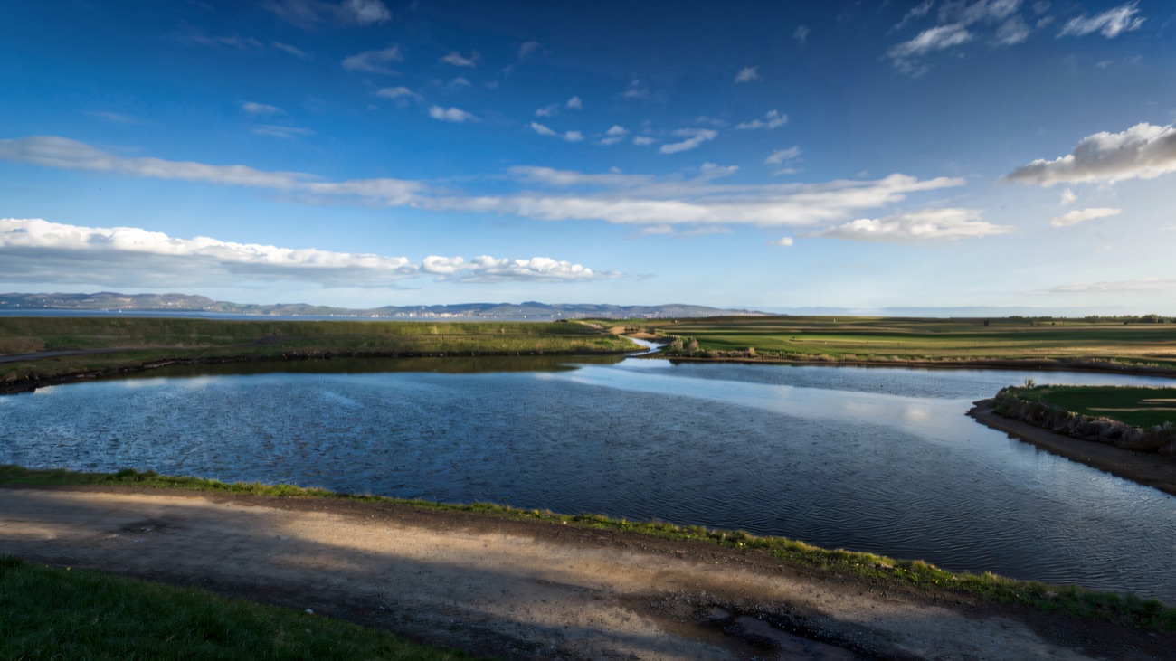 A still tidal lagoon reflecting the Donegal hills across the Foyle