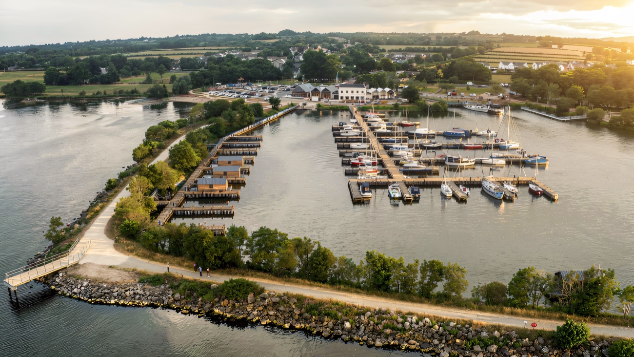 Ballyronan Marina reaching out into Lough Neagh, with the shore path and moored boats.