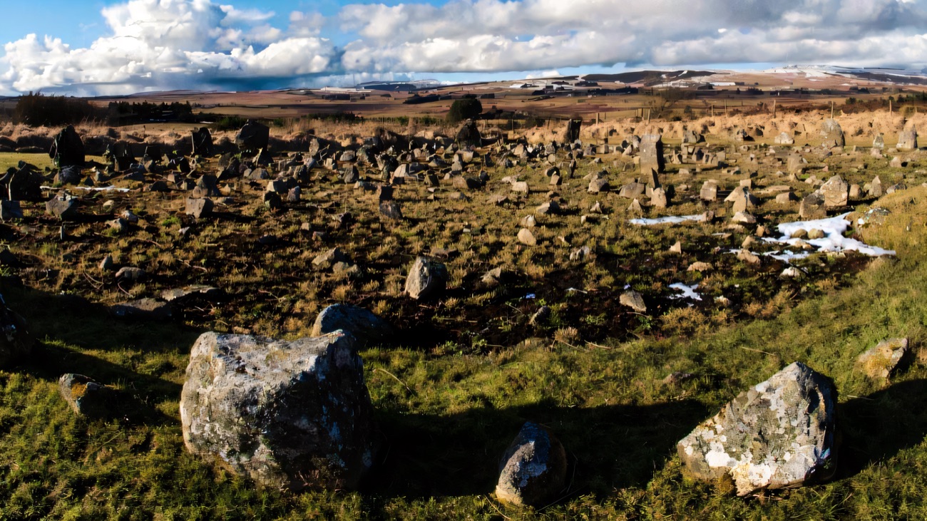 A winter panorama across the circles, with snow lying on the Sperrin hills beyond.
