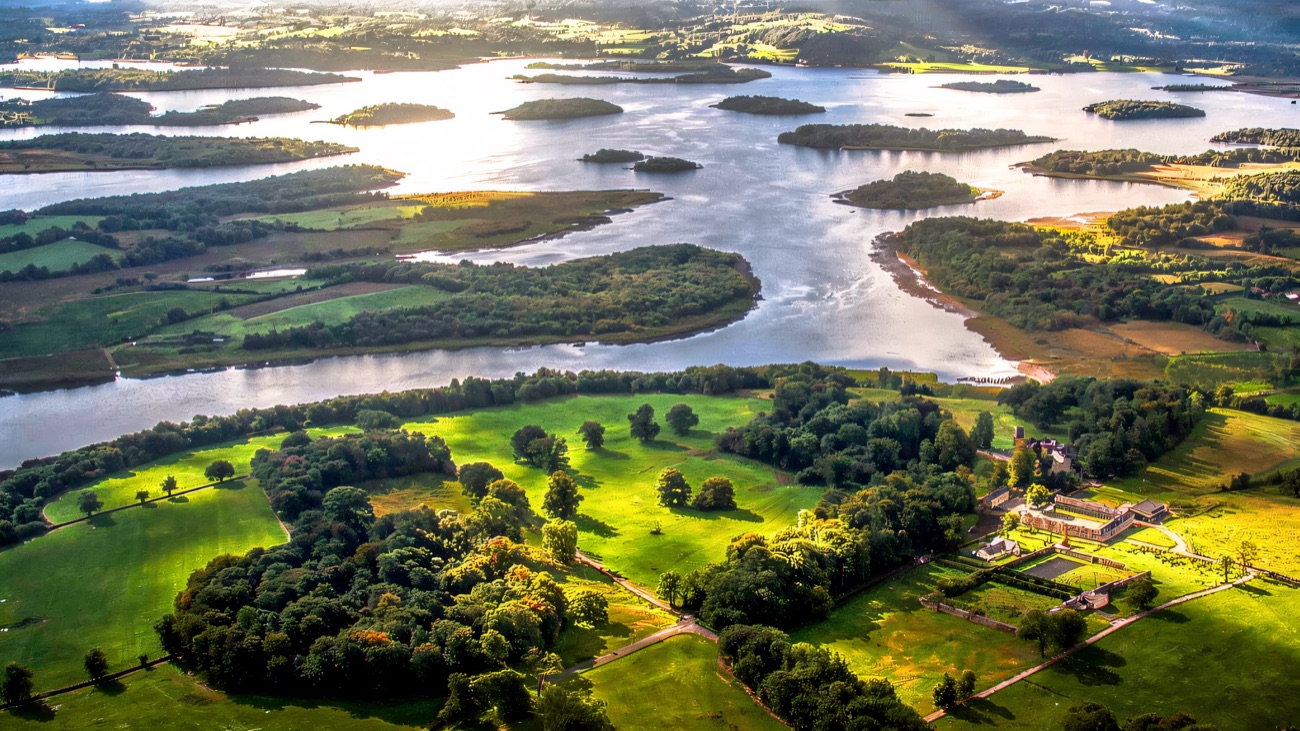 An aerial view of Upper Lough Erne, a maze of green islands and drumlins in a wide silver lough