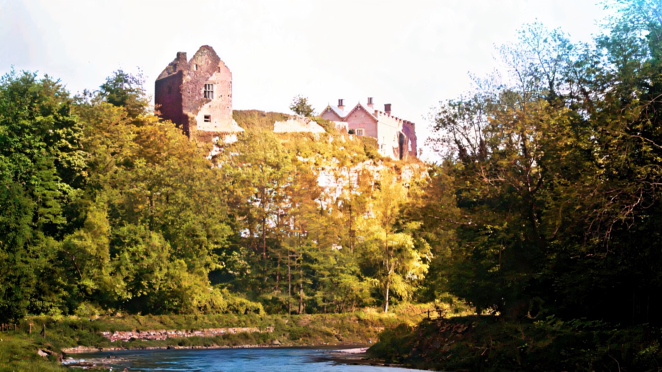 Benburb Castle perched high on the cliff, its towers rising out of the trees above the River Blackwater running below