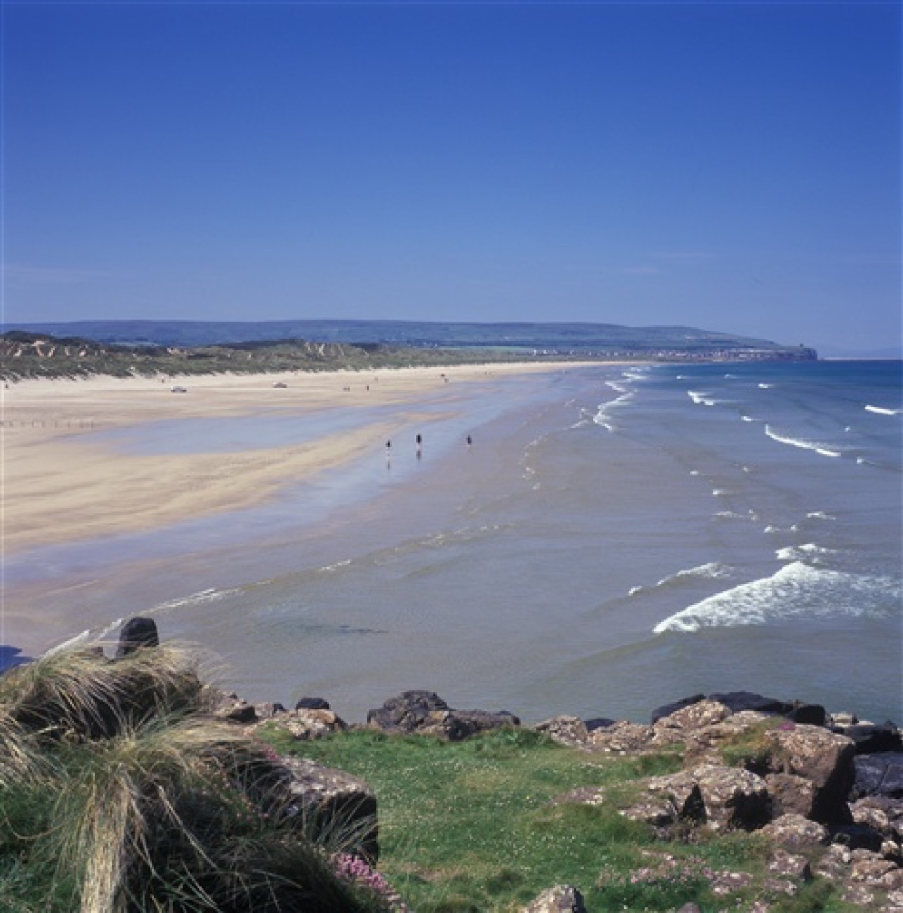 The rocky shore at Port na Happle looking along the coast towards Portstewart Strand