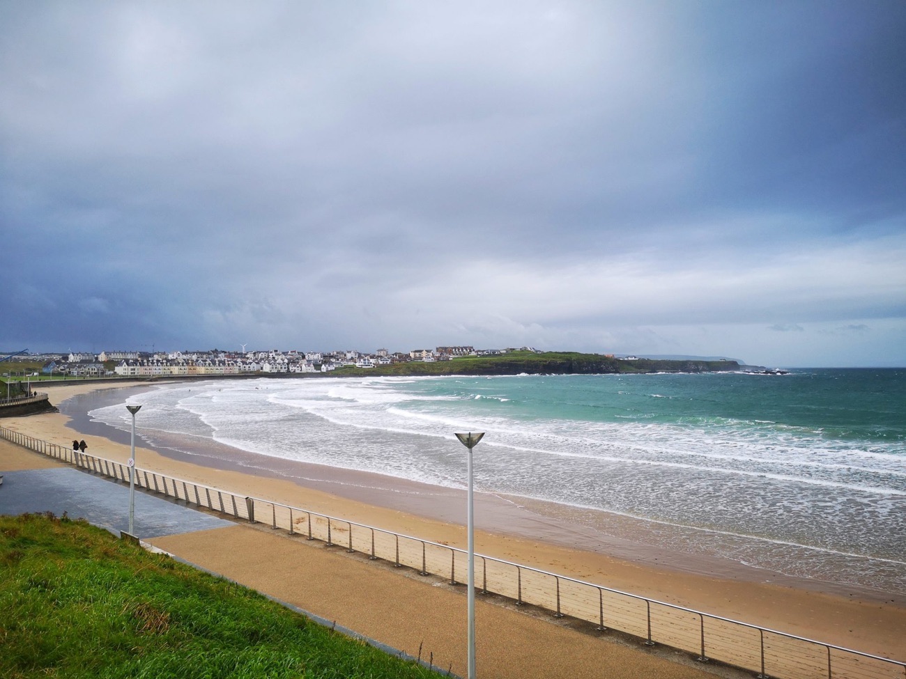 West Strand at Portrush with rocks at the water's edge and the town behind