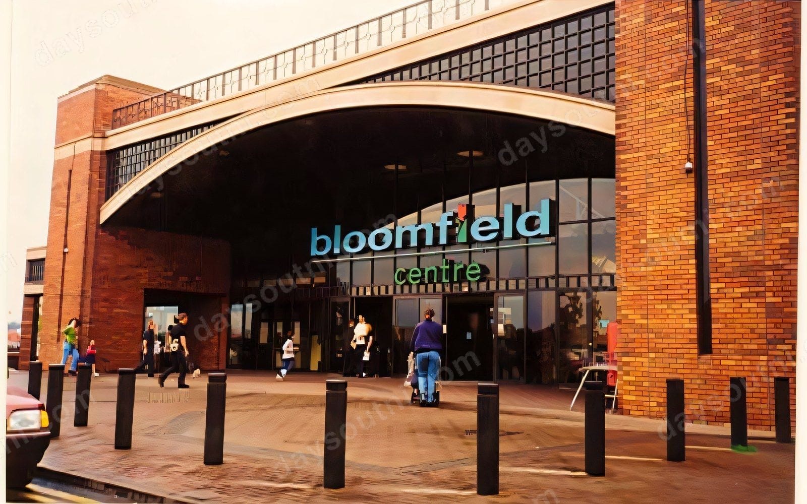 The main entrance of Bloomfield Shopping Centre in Bangor, with its curved glass frontage and red-brick towers over the Bloomfield Centre sign