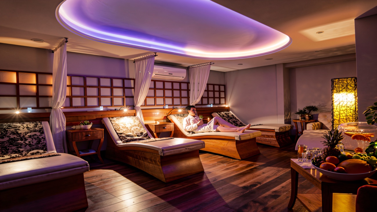 Heated loungers under soft mood lighting in the relaxation room.