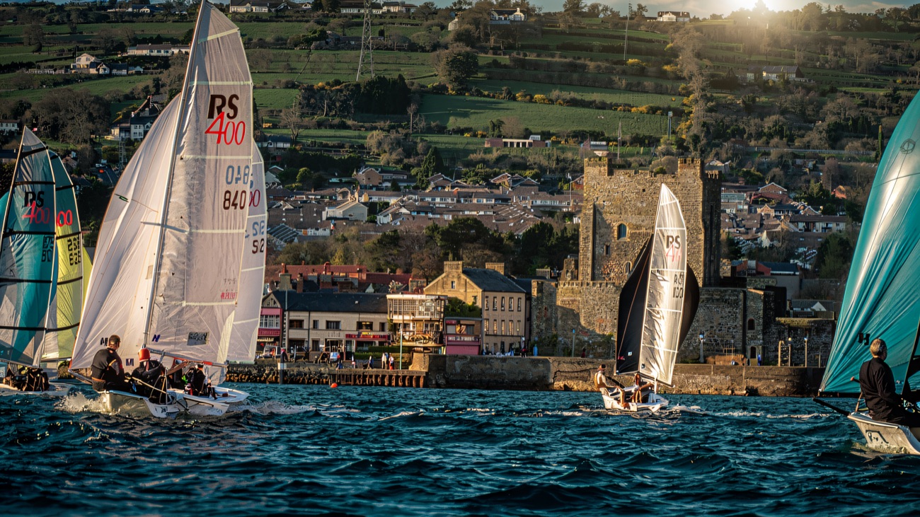 RS400s racing hard off Carrickfergus with the castle keeping watch