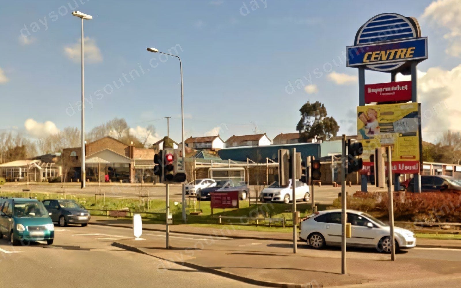 The Carryduff Shopping Centre site seen from the main road junction, with the tall CENTRE sign by the roadside