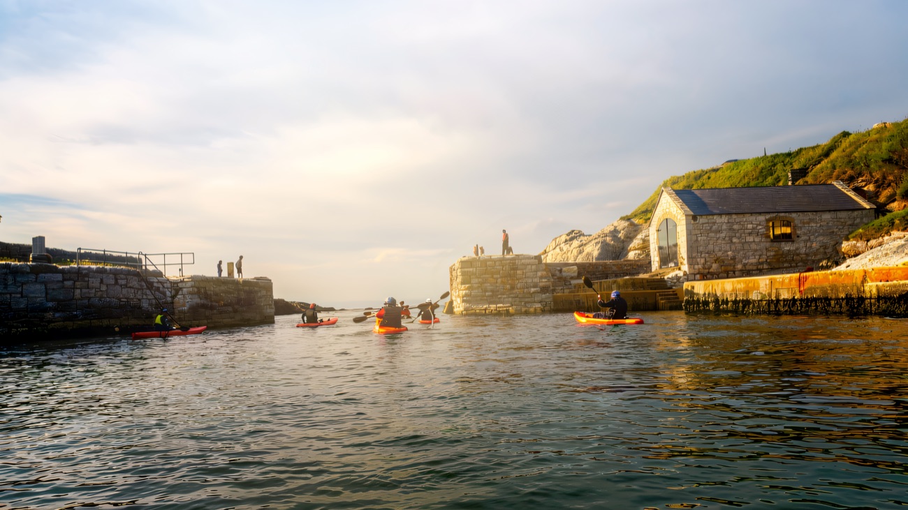 Setting off from the old stone harbour, boathouse standing guard
