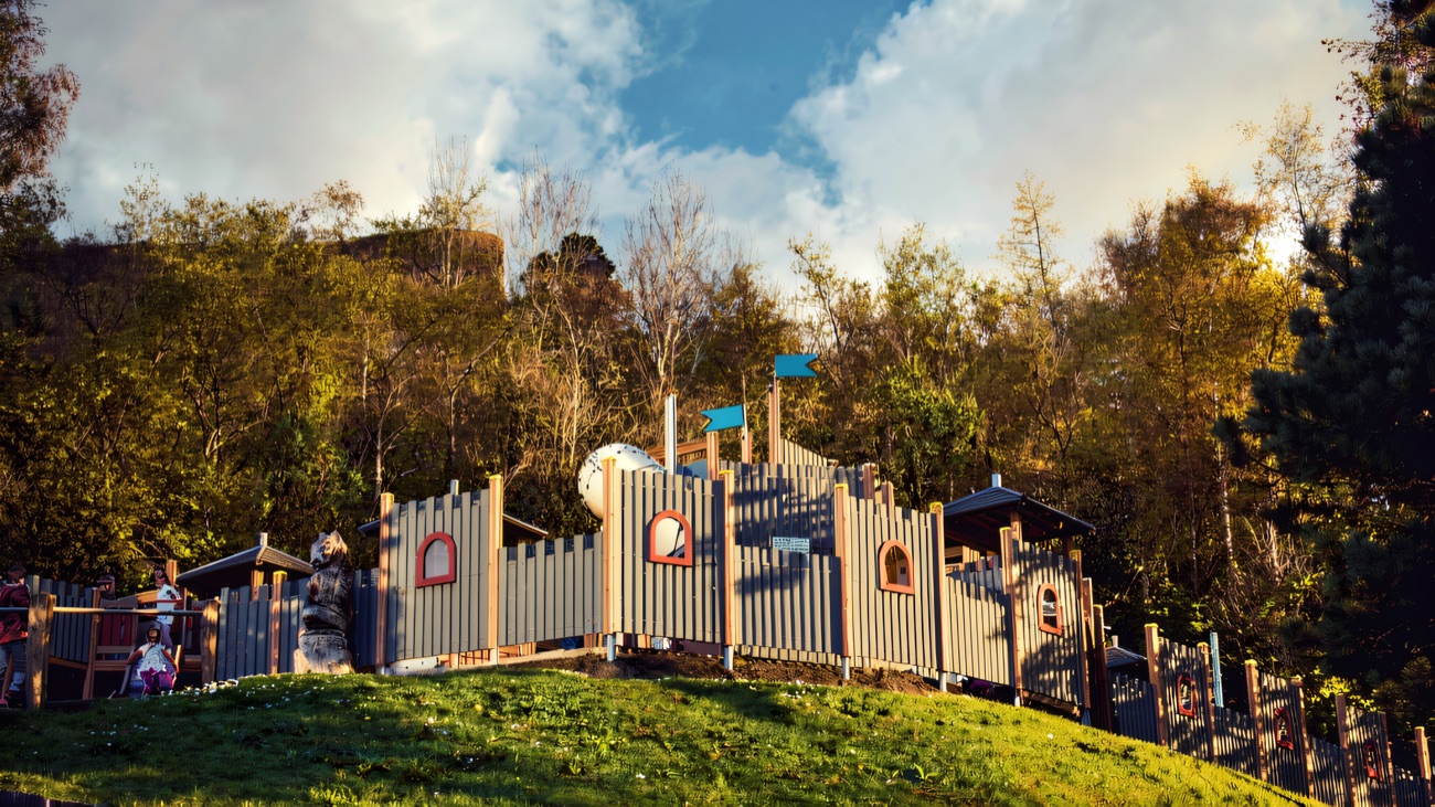 The timber castle ramparts on the hill under a bright blue sky