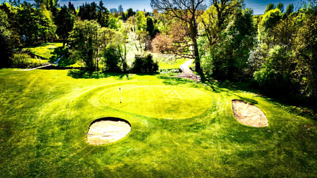 A manicured golf green and bunkers from above
