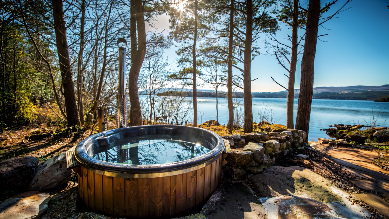 A wood-fired hot tub set among the pines overlooking the lough