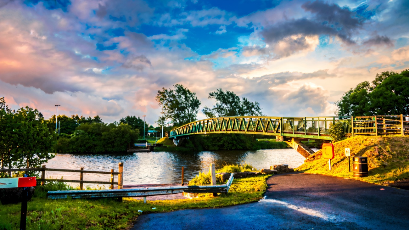 The green footbridge arching over the water at Craigavon Lakes
