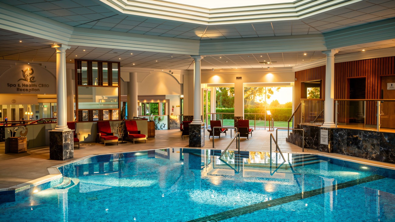 Loungers line the poolside beside the spa and health club reception.