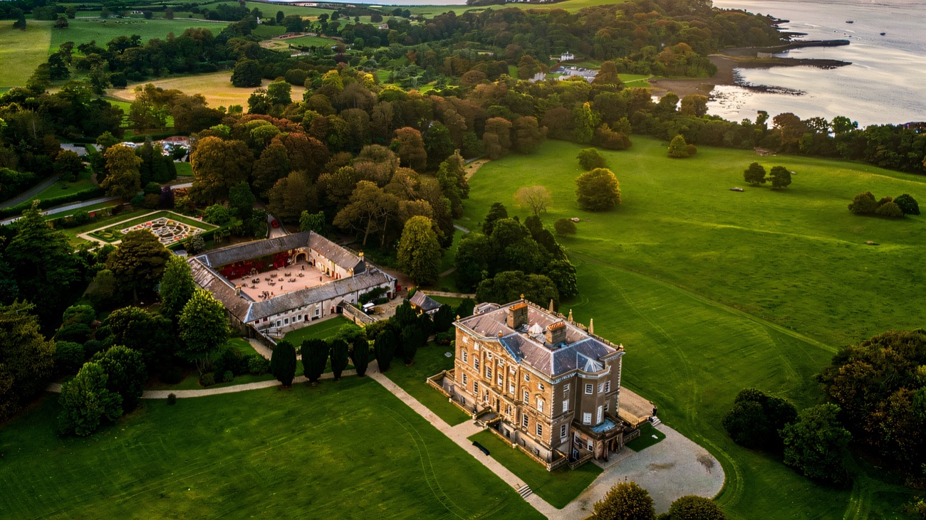 Aerial view of the Castle Ward estate, farmyard and woods on the shore of Strangford Lough