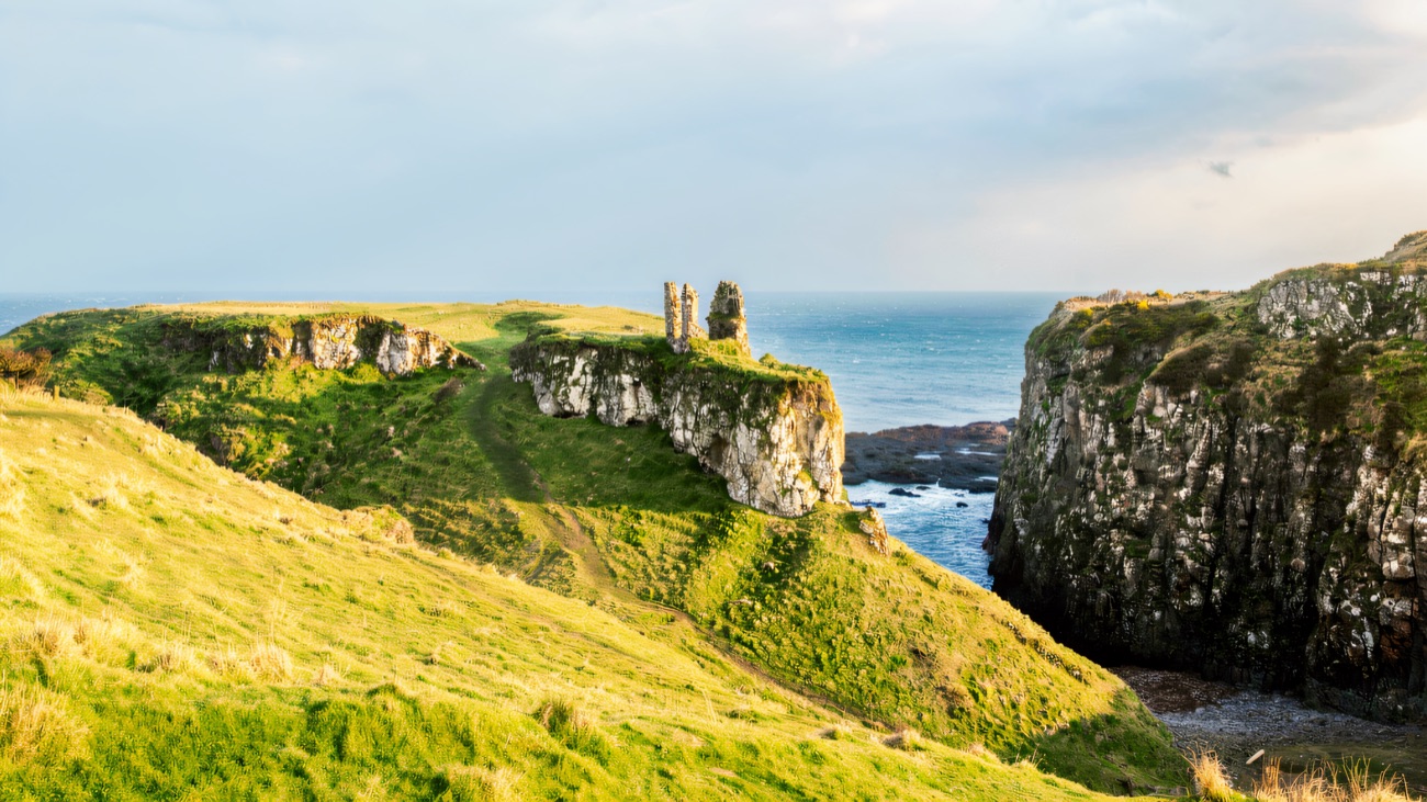 Softer evening light picks out the ruin at the tip of the coastal path near the Giant's Causeway.