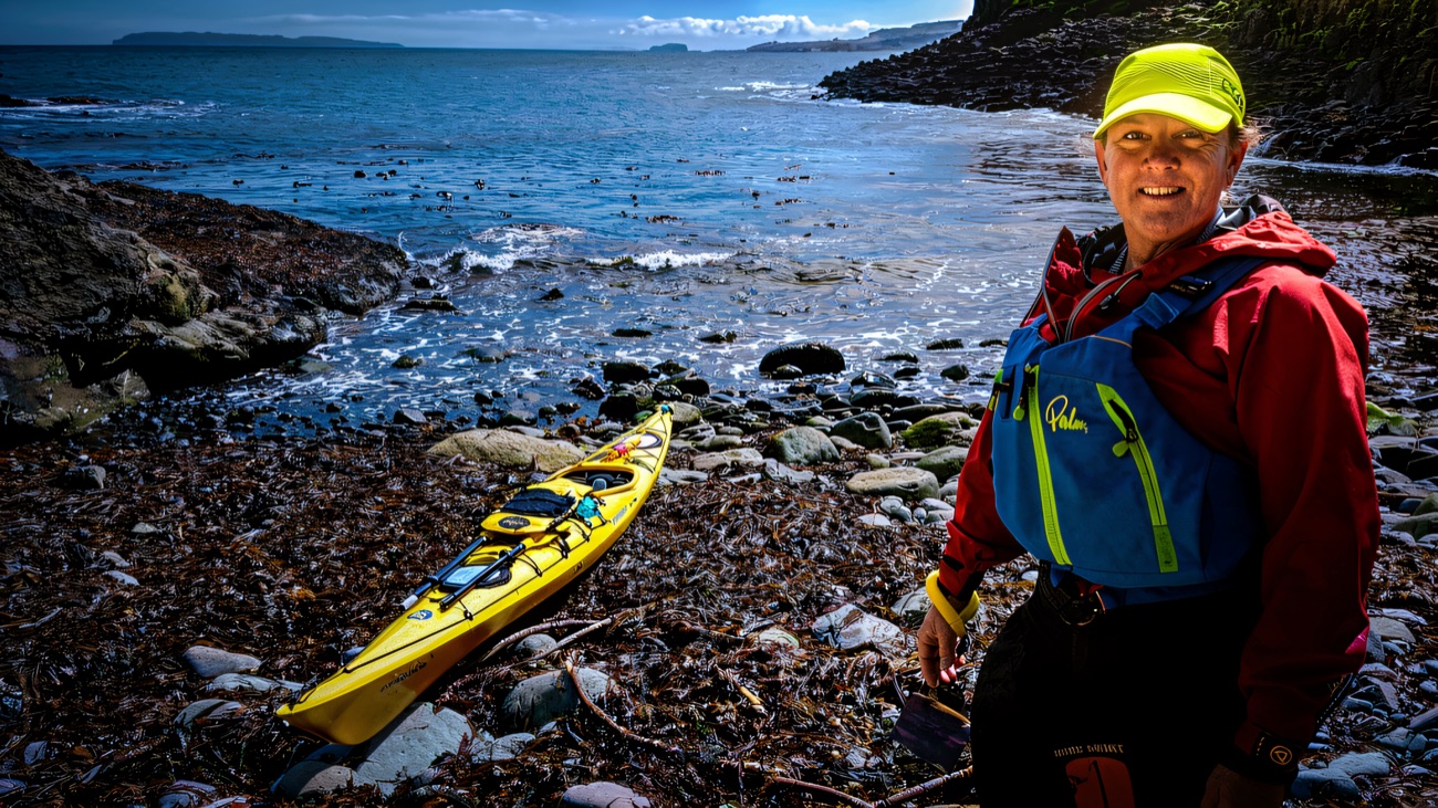 Sea kayak beached on the Causeway stones, open water stretching to the horizon