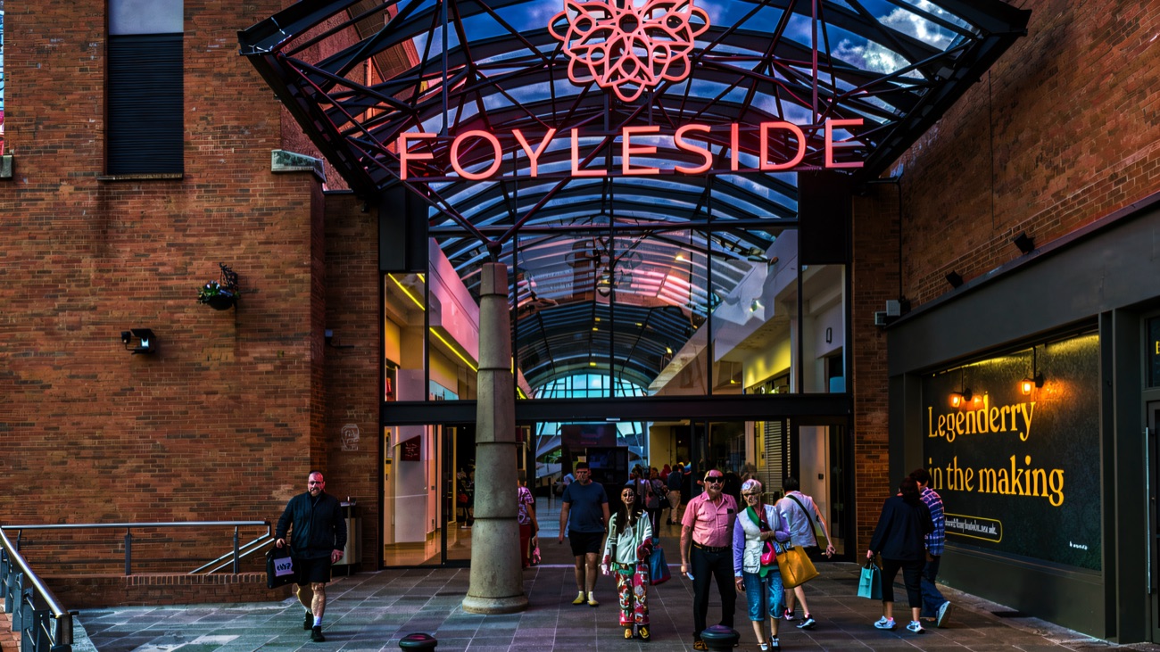 The Orchard Street entrance to Foyleside Shopping Centre, with its curved steel-and-glass canopy and the Foyleside name above the doors