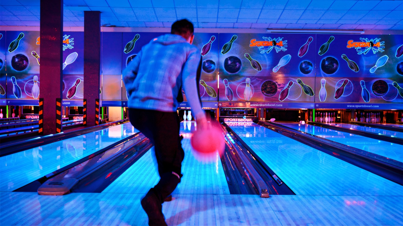 A bowler releasing the ball down the lane