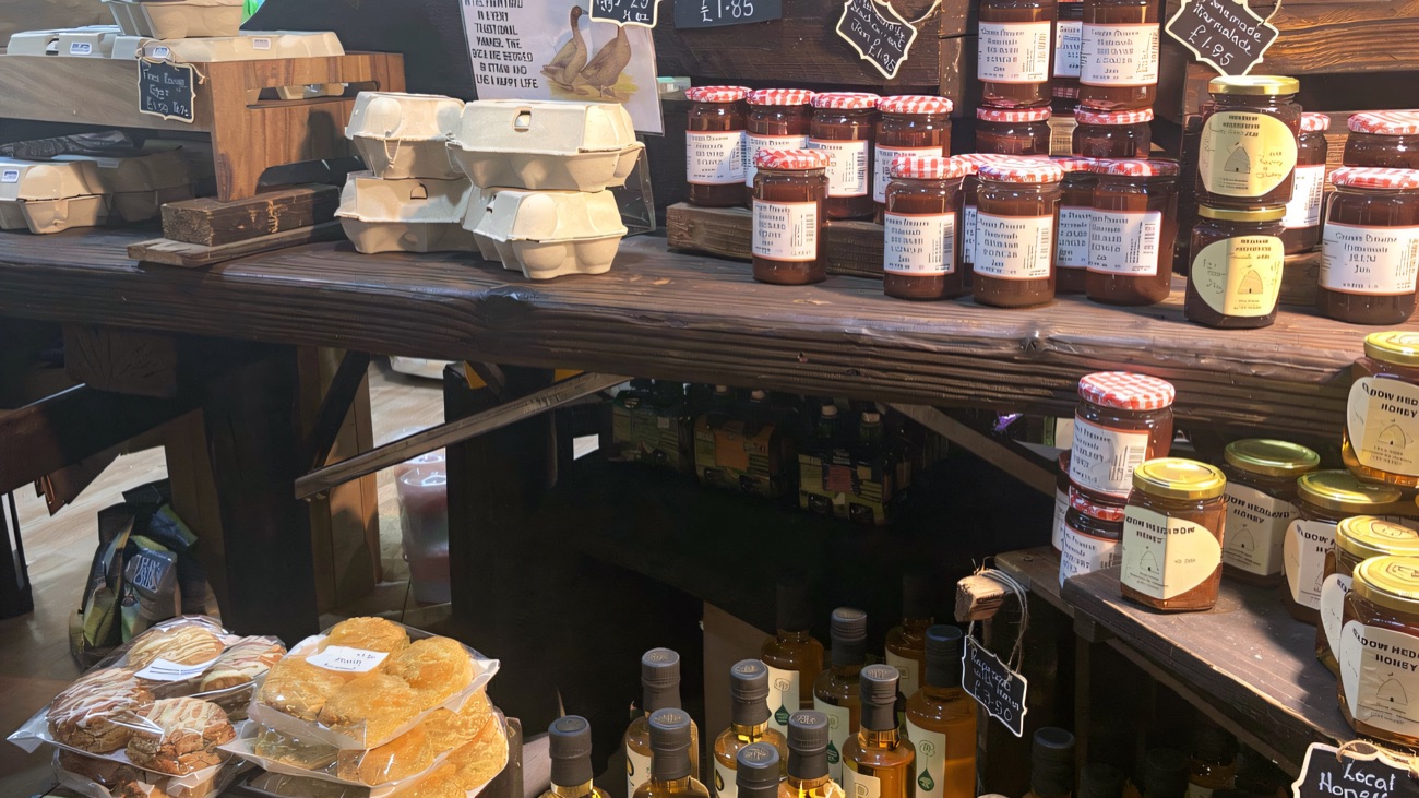 Inside the farm shop — shelves of homemade jams, local honey, free-range eggs and fresh scones