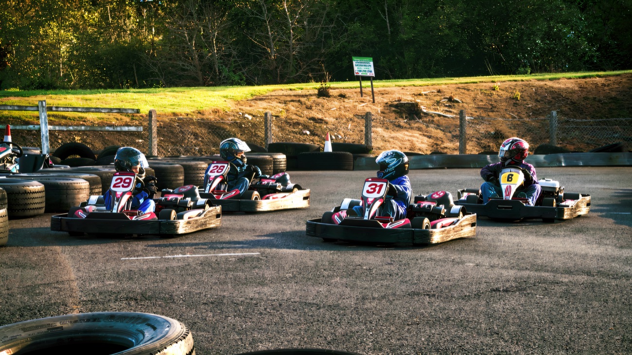 Karts running side by side past the tyre wall