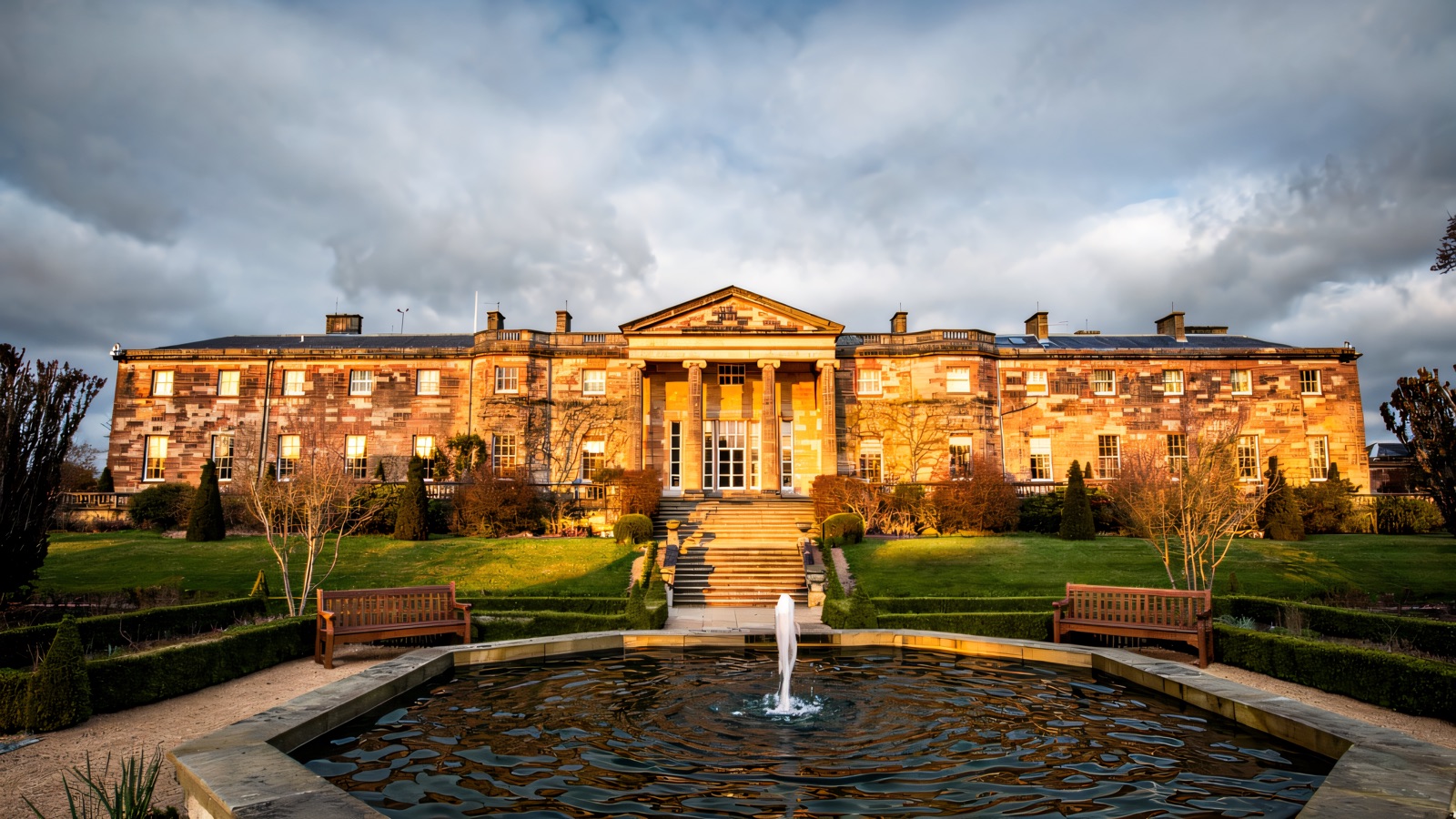 The Georgian front of Hillsborough Castle with a fountain and clipped garden below