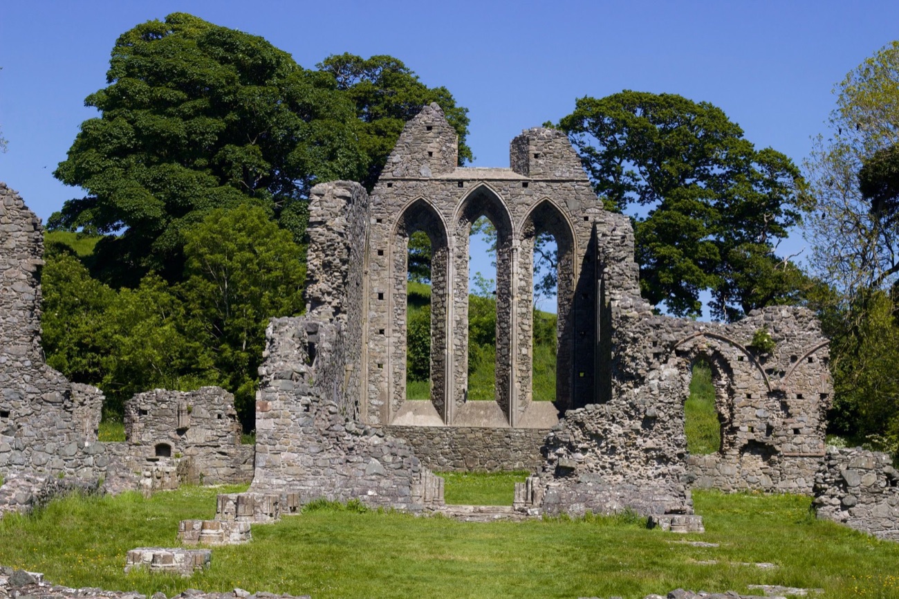 The tall triple-lancet east window of Inch Abbey standing against the sky