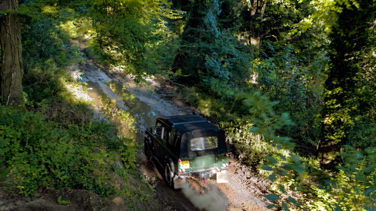 A 4x4 threading a woodland track from above