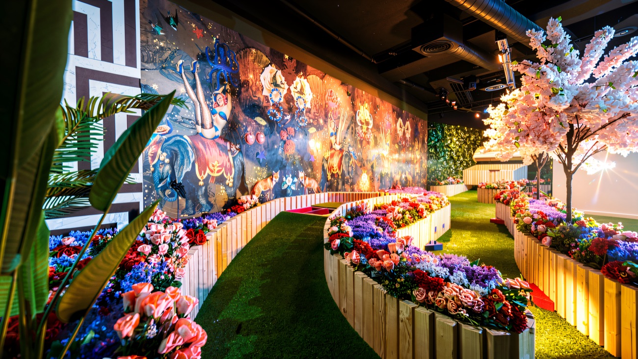 Players putting through the blooms on the indoor floral course