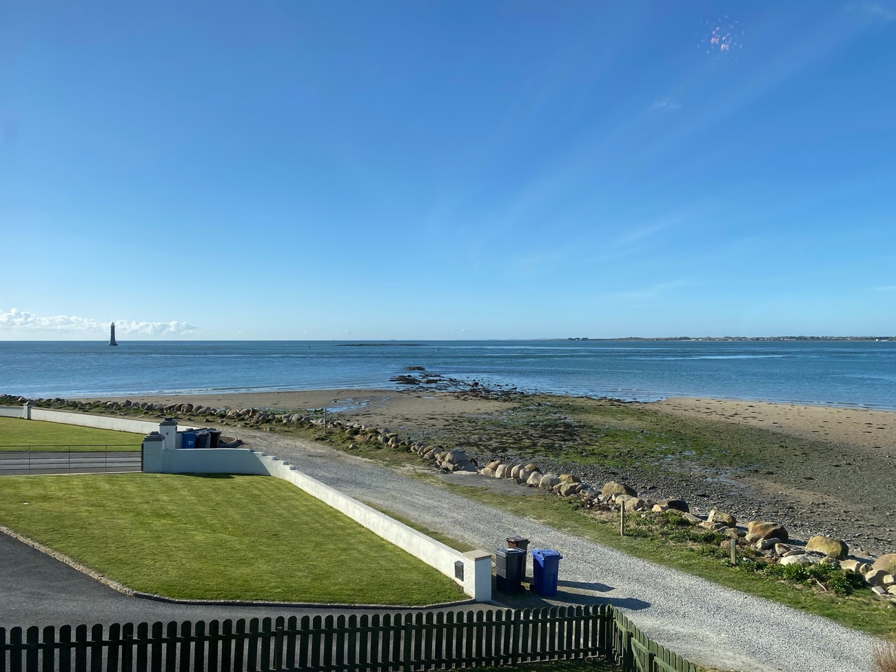 The sandy shore at Cranfield looking out to Carlingford Lough with Haulbowline Lighthouse on the horizon