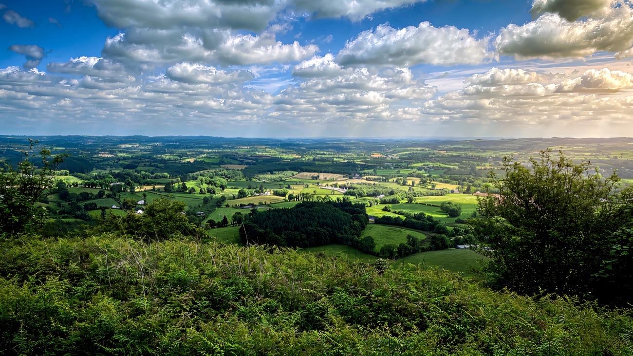 The wide view over the patchwork Clogher Valley from the hilltop.
