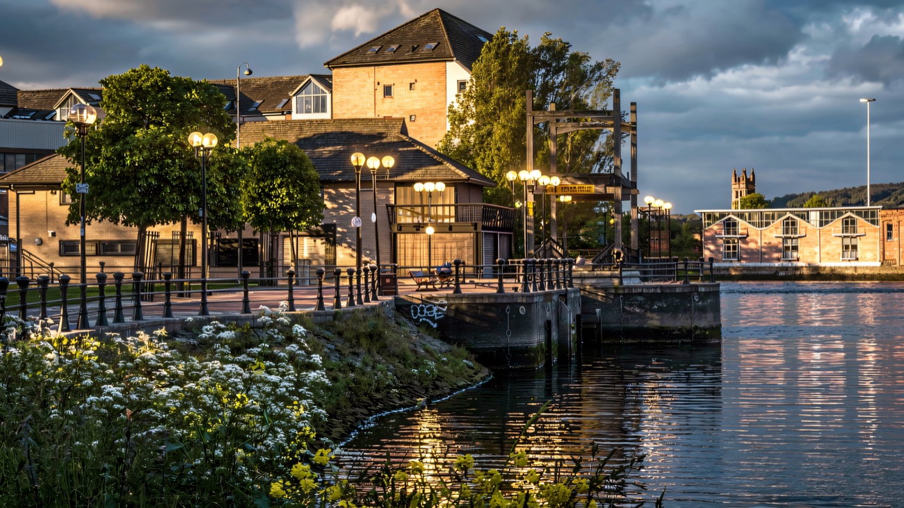 The old weir and quayside where the towpath meets the city