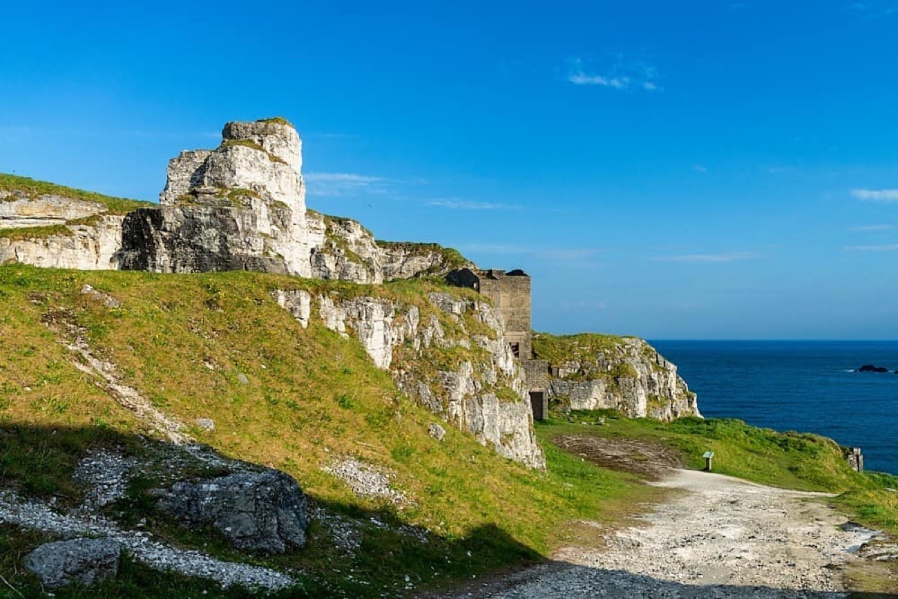 Weathered limestone stacks and old quarry ruins on the Larrybane headland above the sea