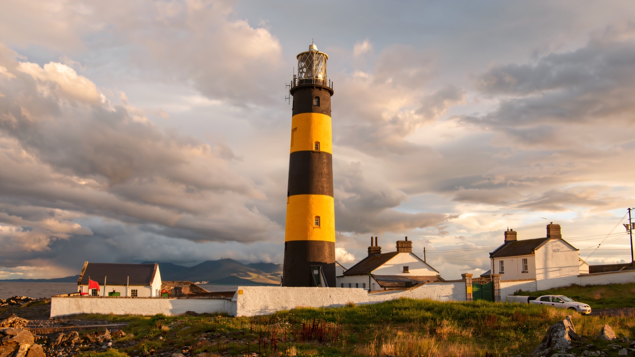 The striped lighthouse with the Mourne Mountains hazy behind