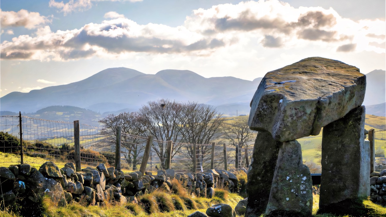 The three-legged dolmen with the Mourne Mountains rising behind.