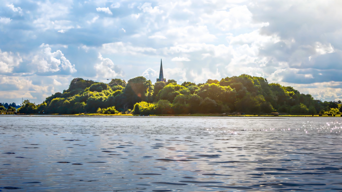 Church Island seen low across the water, its spire lifting above the treeline.