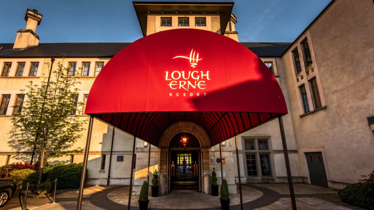 The red arched entrance canopy of Lough Erne Resort, marked with the resort's crest