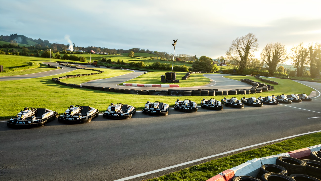 A fleet of karts lined up on the outdoor track at Lyons Karting