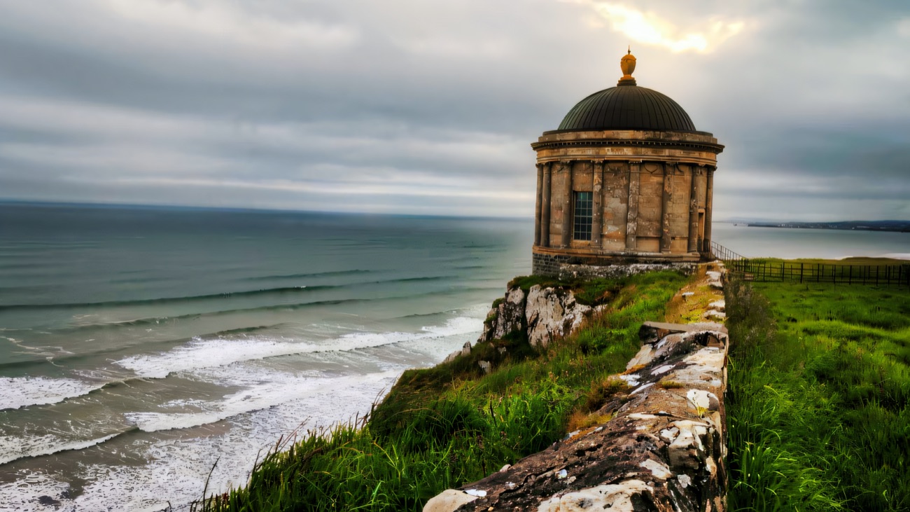 Mussenden Temple on the very edge of the cliff above a wild grey sea