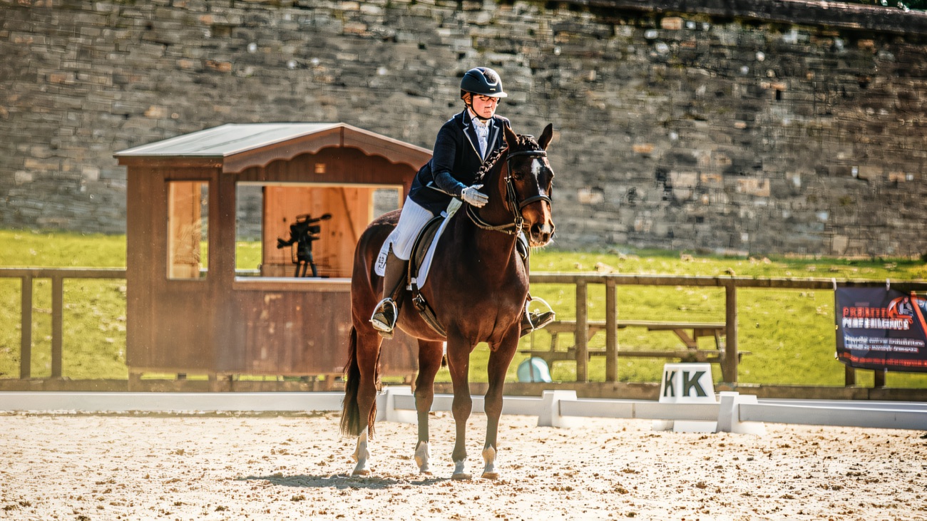 A dressage test underway in the walled arena