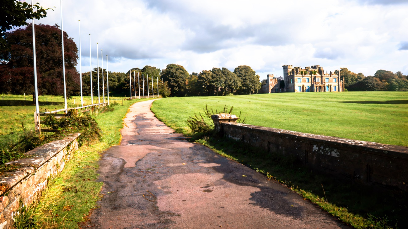 A tree-lined avenue across the Necarne estate parkland leading up towards the castle in the distance