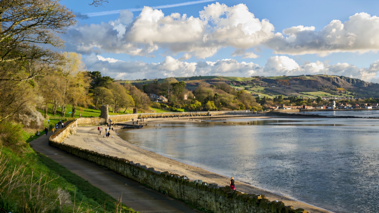 The loughshore path curving along Belfast Lough with Cave Hill beyond