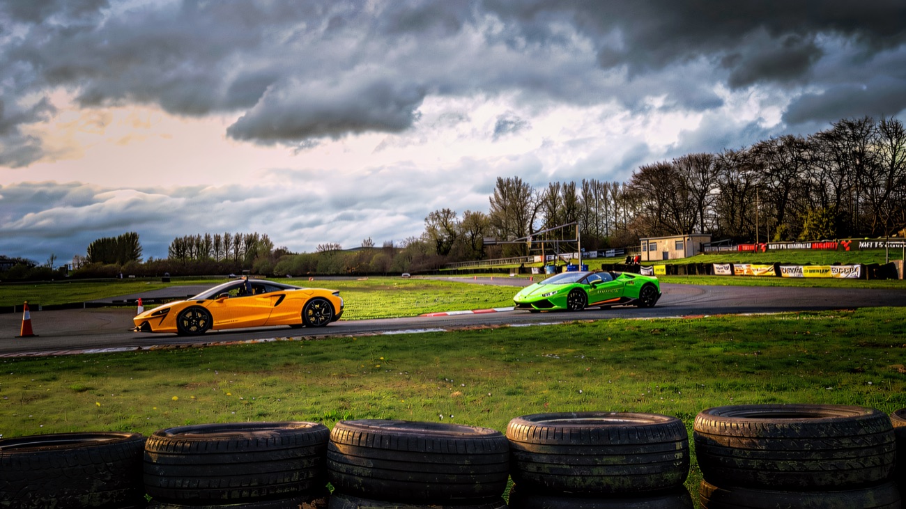 Supercars out on the circuit, with the trackside banners behind
