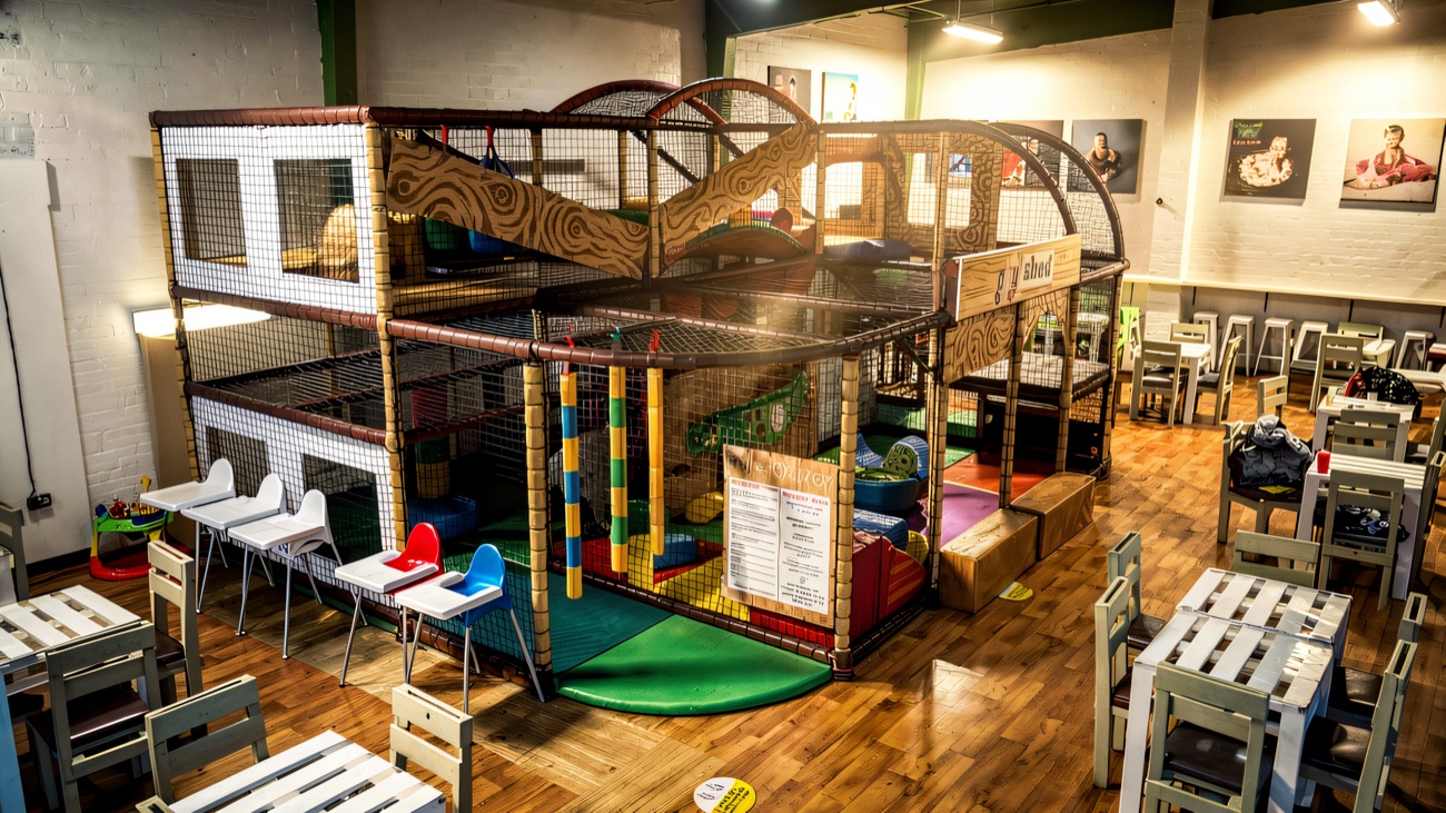 The multi-level play frame seen from above, with café tables and highchairs alongside