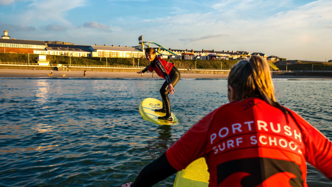 An instructor sends a rider down the line off Portrush strand